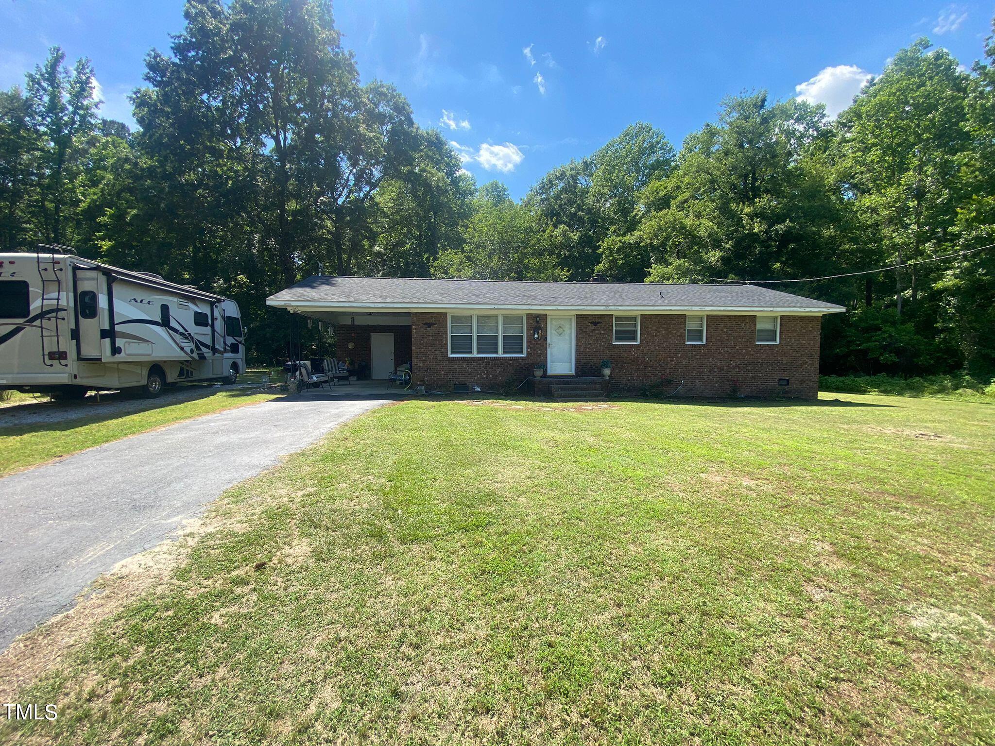 3933 Lizard Lick Road Wendell, NC 27591 - Photo 1 of 25 a view of a house with a swimming pool