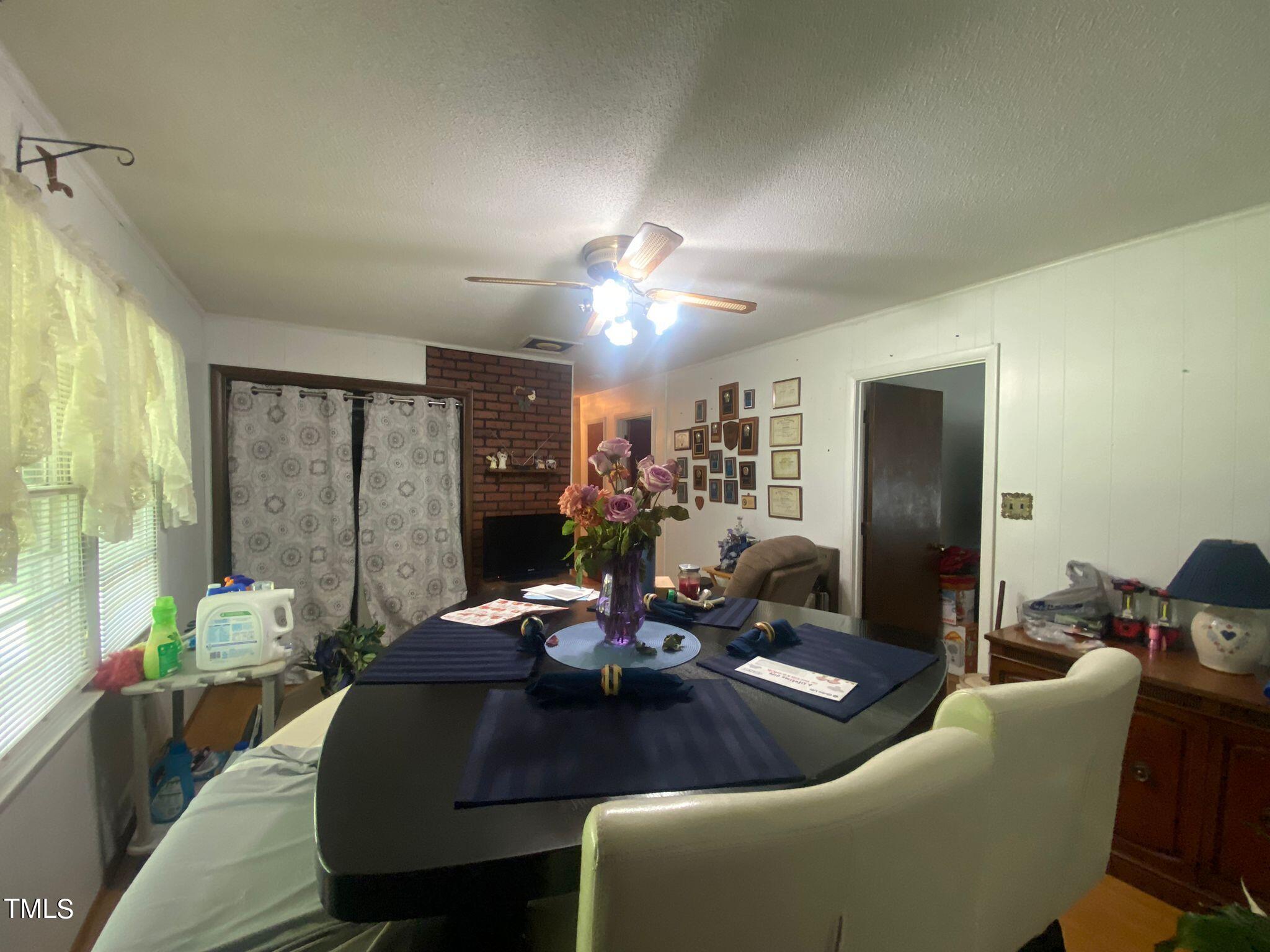 3933 Lizard Lick Road Wendell, NC 27591 - Photo 11 of 25 a living room with furniture and large windows