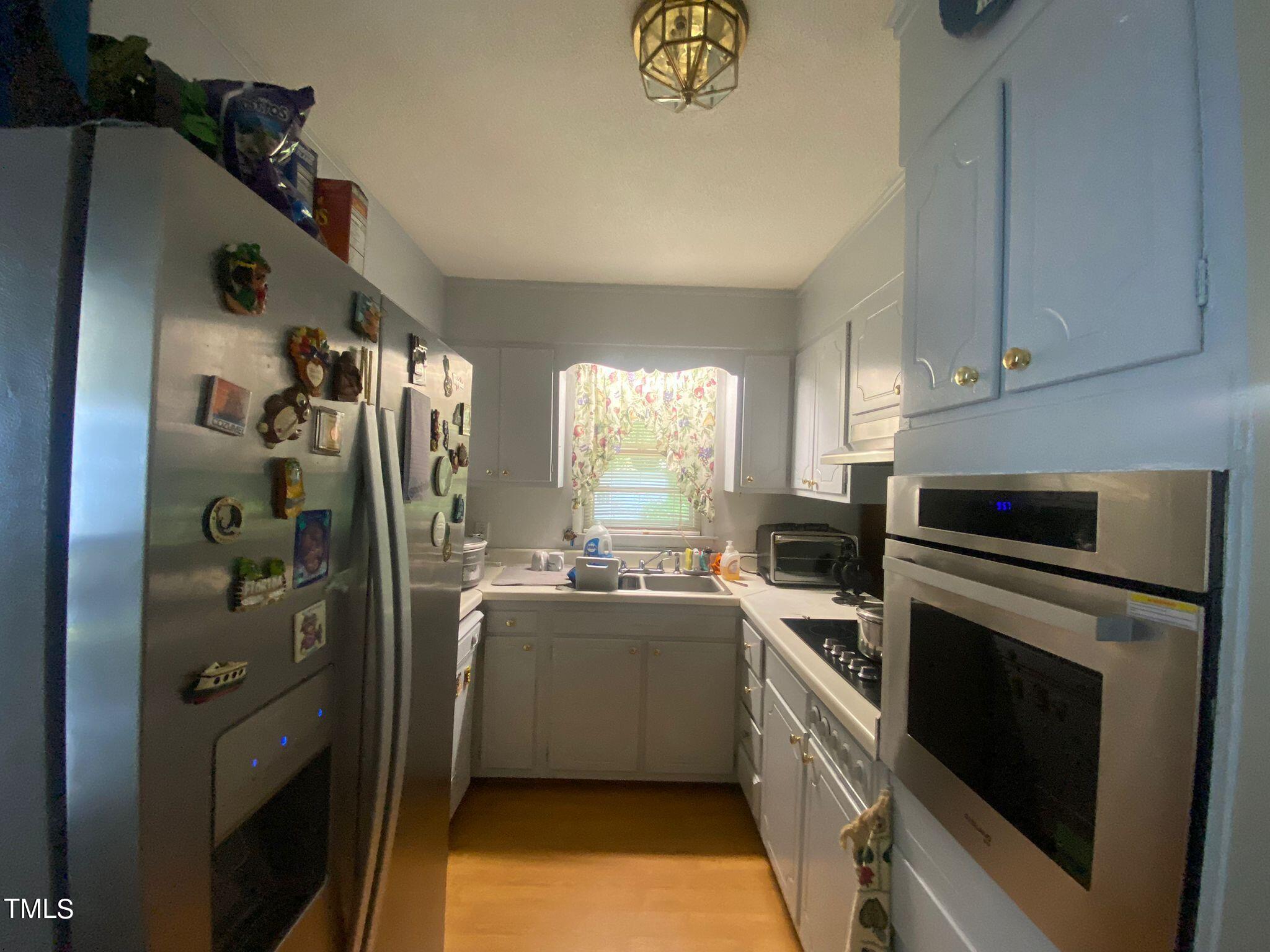 3933 Lizard Lick Road Wendell, NC 27591 - Photo 14 of 25 a kitchen with stainless steel appliances granite countertop a refrigerator a stove and a sink