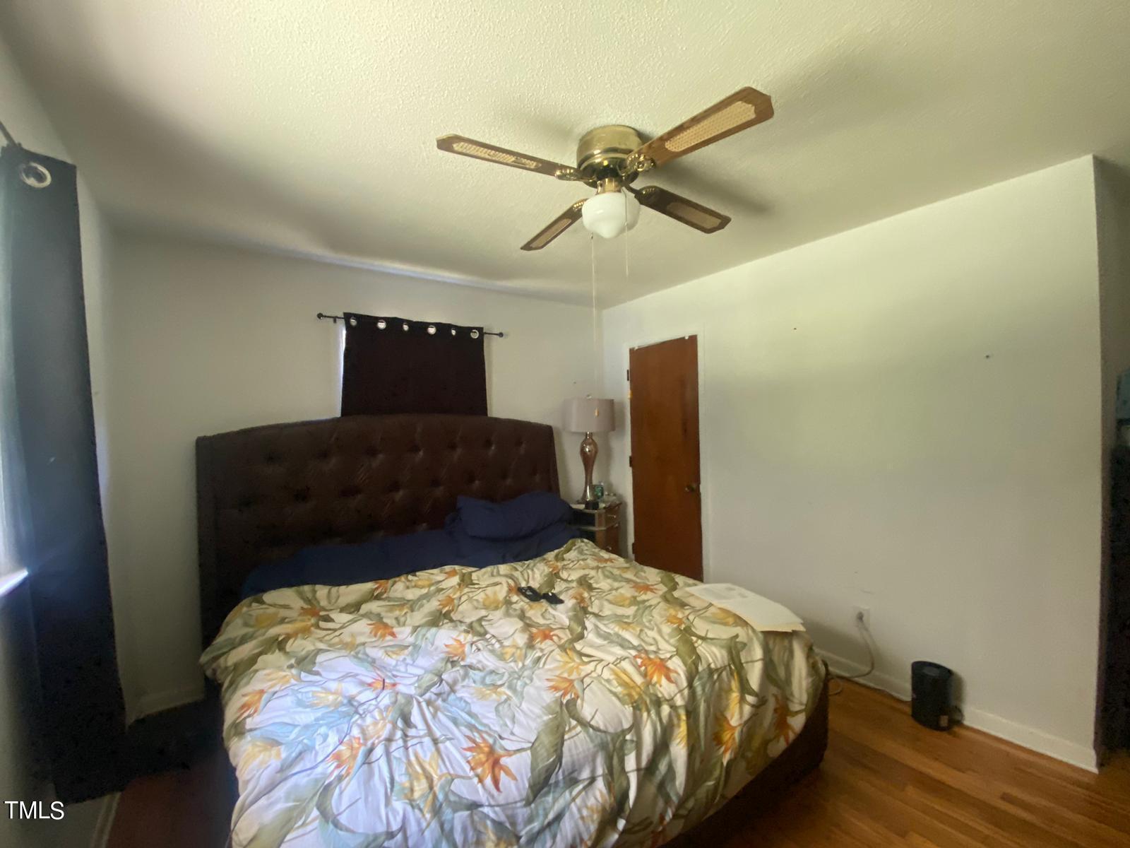 3933 Lizard Lick Road Wendell, NC 27591 - Photo 17 of 25 a bedroom with a bed and wooden floor