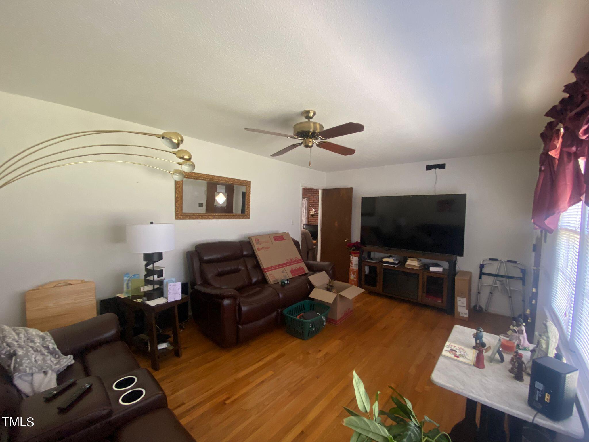 3933 Lizard Lick Road Wendell, NC 27591 - Photo 5 of 25 a living room with furniture and a flat screen tv
