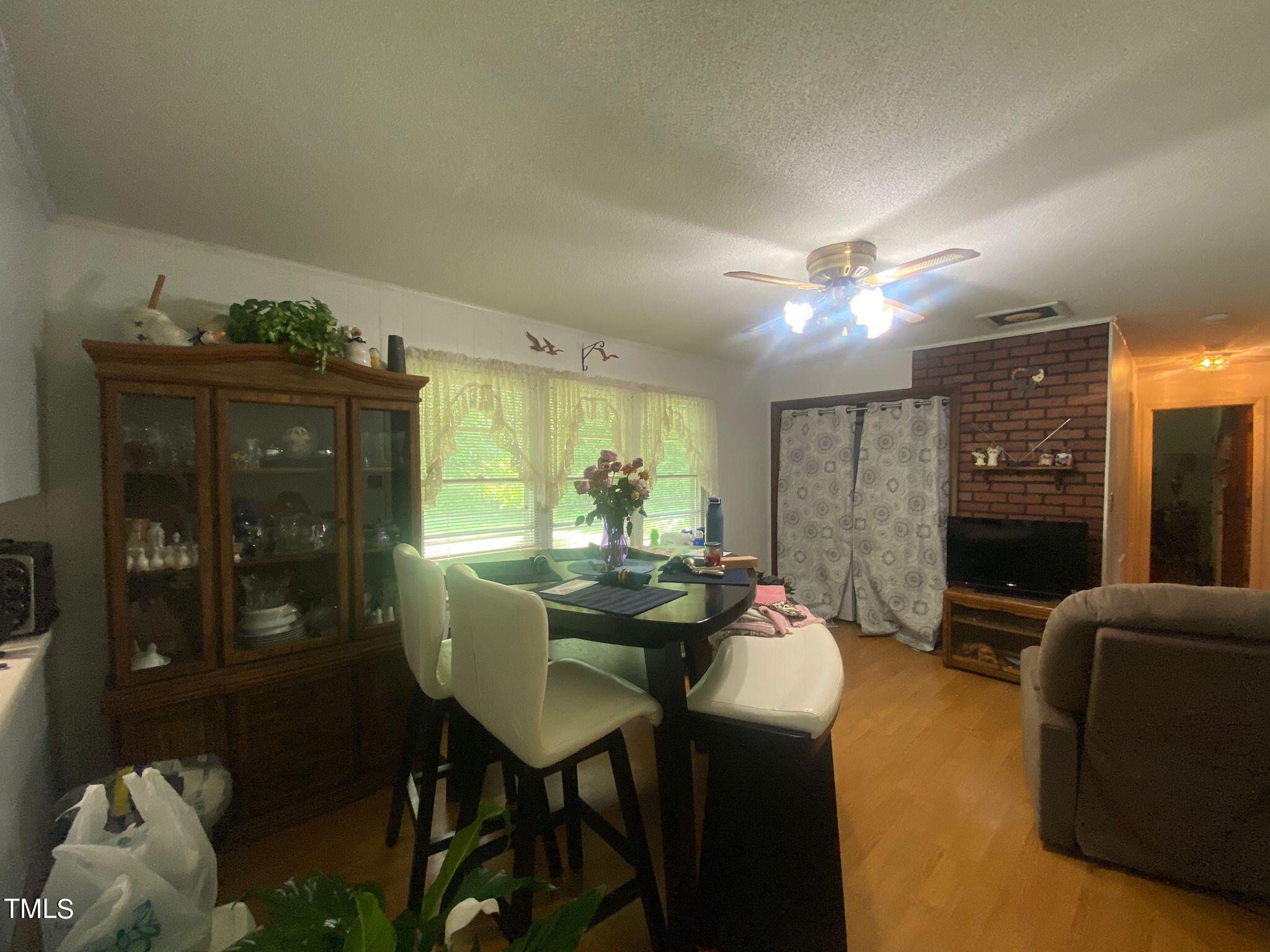 3933 Lizard Lick Road Wendell, NC 27591 - Photo 7 of 25 a view of a dining room with furniture and chandelier