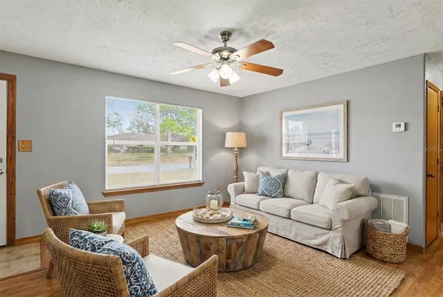 a living room with furniture and a large window