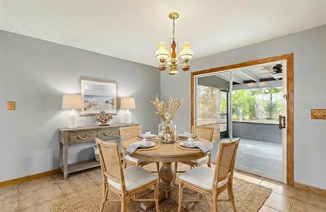 a view of a dining room with furniture wooden floor and chandelier