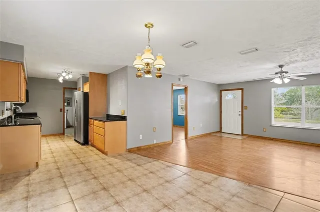 a view of a kitchen with granite countertop a sink cabinets and a stove