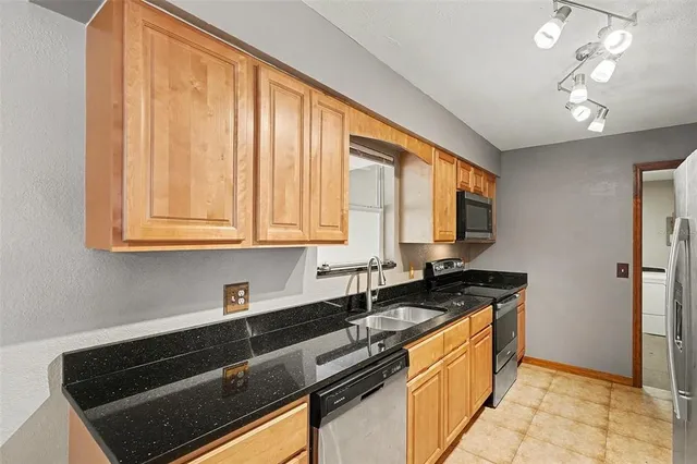a kitchen that has a sink and a stove