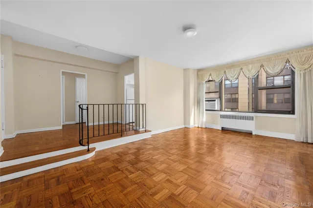 a view of an empty room with stairs