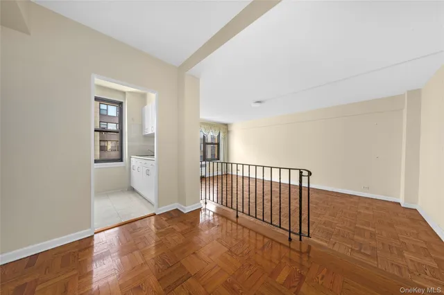 a view of a hallway with wooden floor and entryway