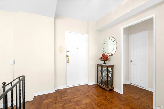 a view of a hallway with wooden floor and entryway