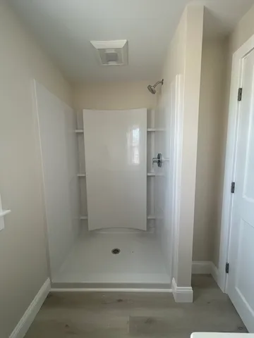 a view of a room with wooden floor and windows