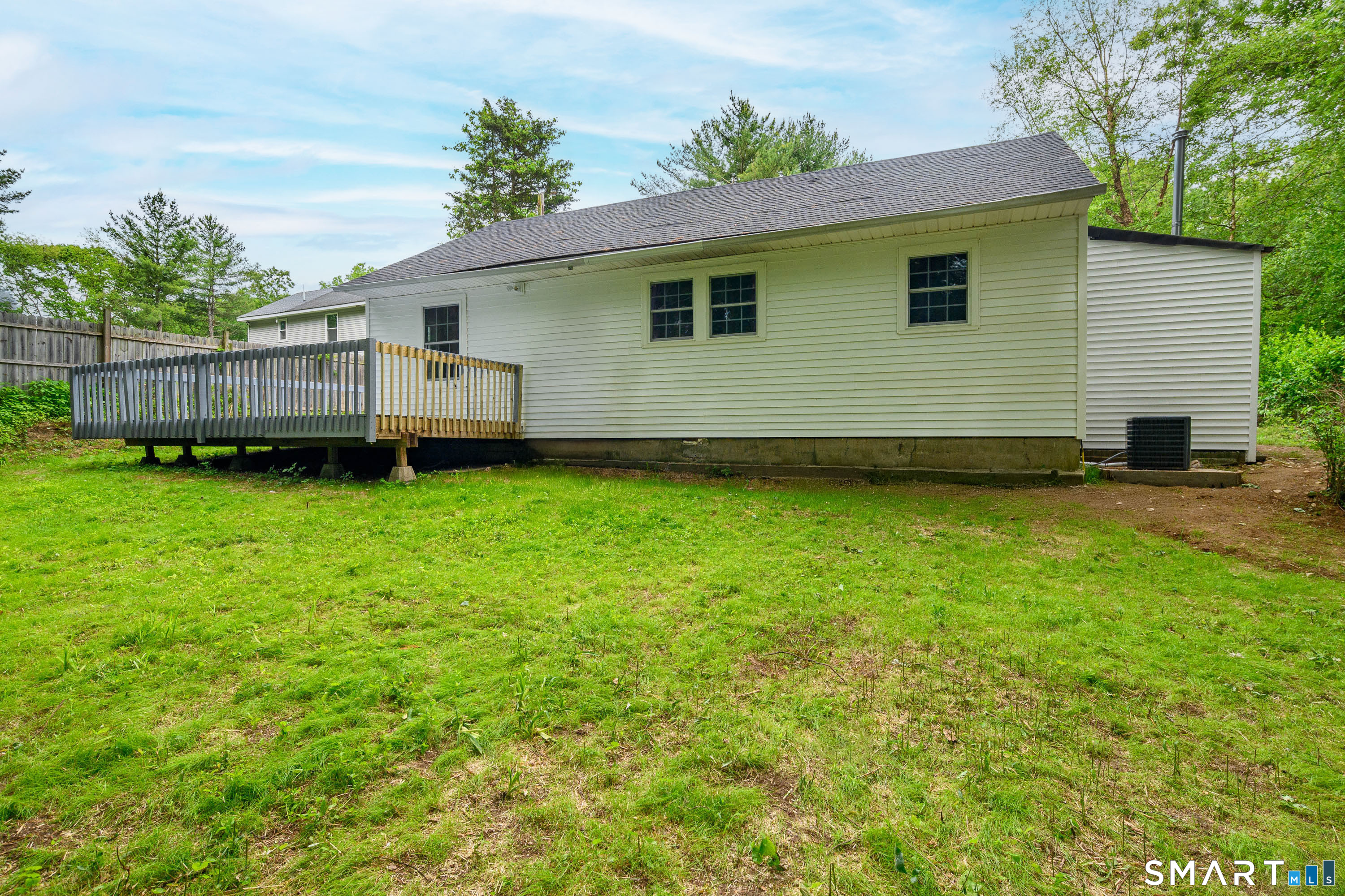 3 Botsford Hill Road Newtown, CT 06470 - Photo 23 of 25 Full rear view of home highlighting deck access and yard space.