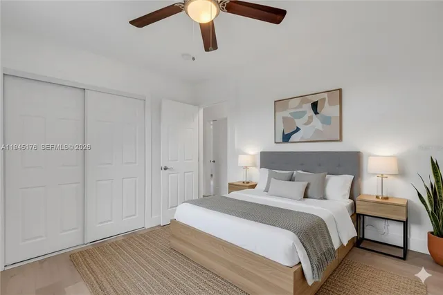 a bedroom with a bed and a painting on the wall