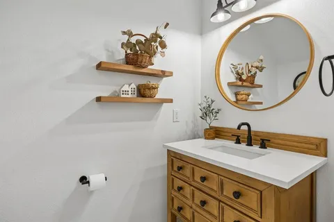a bathroom with a sink and a mirror