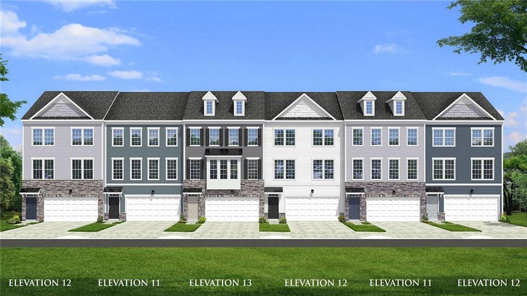 a front view of a residential apartment building with a yard