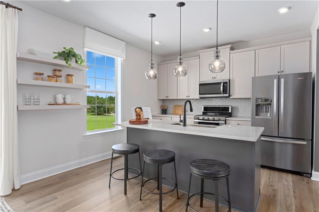 115 Affinity Drive Harmony, PA 16037 - Photo 2 of 16 a kitchen with stainless steel appliances a dining table chairs refrigerator and sink