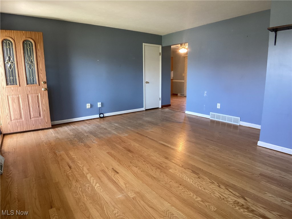 9083 Priem Road Strongsville, OH 44149 - Photo 12 of 28 Spare room with wood finished floors, visible vents, and baseboards