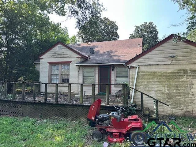 a front view of a house with a garden and plants