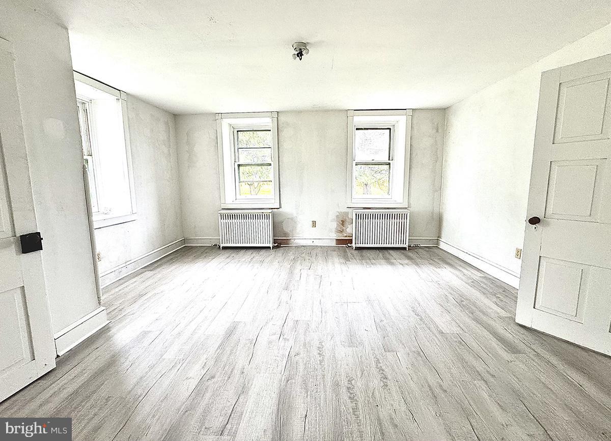 133 Hunter Road Oley, PA 19547 - Photo 15 of 44 an empty room with wooden floor and windows