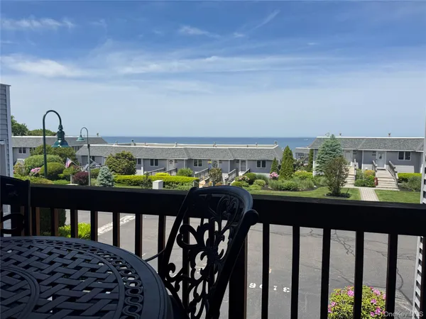 a view of a chairs and table in the balcony