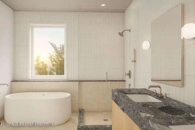 a bathroom with a granite countertop sink and a bathtub