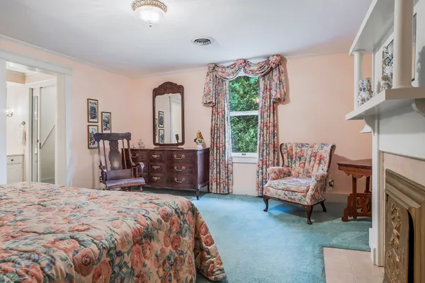 a bedroom with a bed and a fireplace