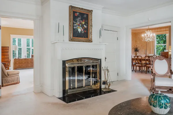 a kitchen with stainless steel appliances granite countertop a sink dishwasher a stove a refrigerator with a dining table and chairs