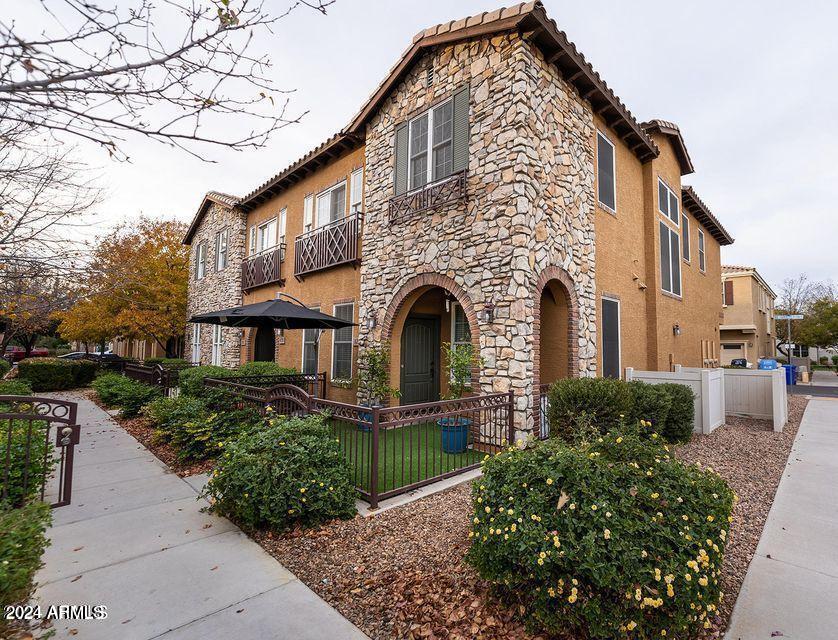 4757 East Waterman Street, Unit 103 Gilbert, AZ 85297 - Photo 1 of 27 a front view of a house with a yard