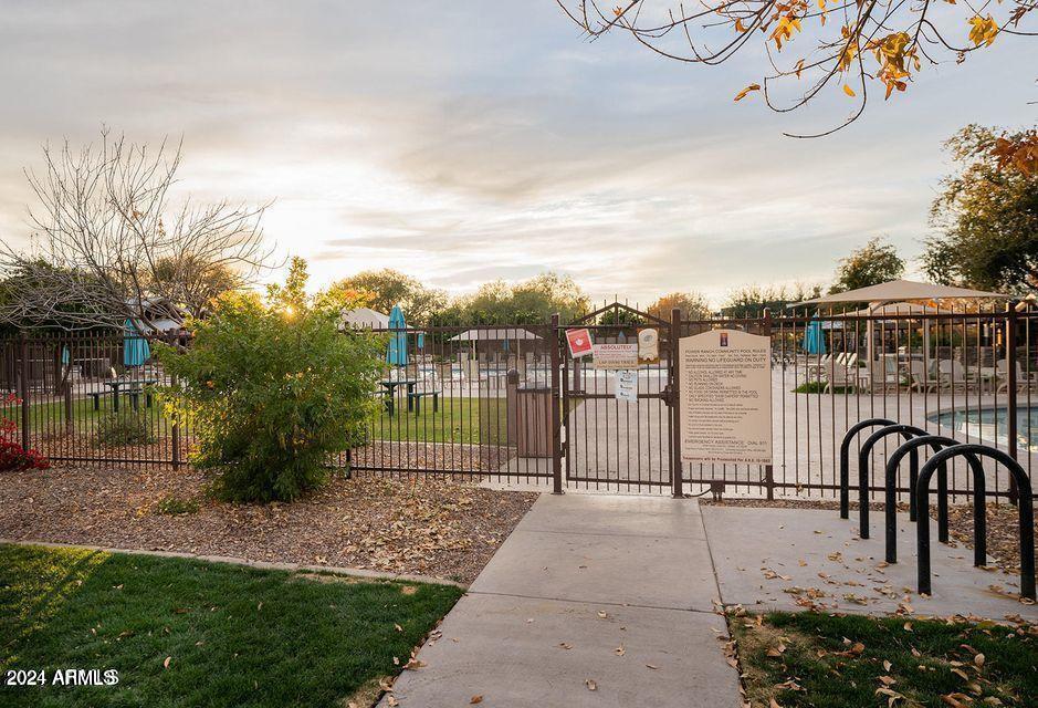 4757 East Waterman Street, Unit 103 Gilbert, AZ 85297 - Photo 14 of 27 a view of a pathway with a wrought fence