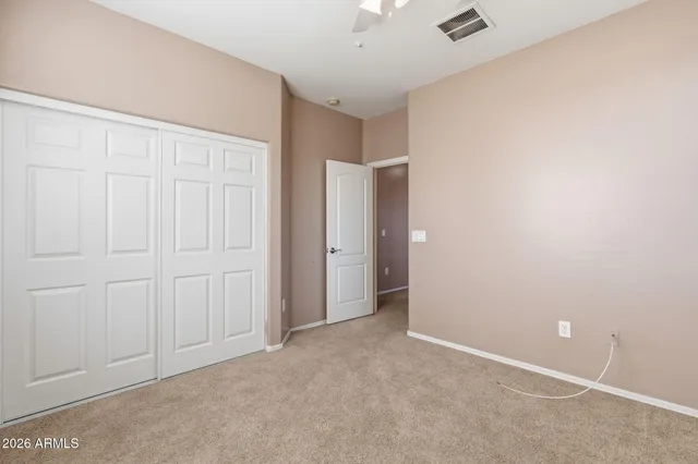 an empty room with closet area