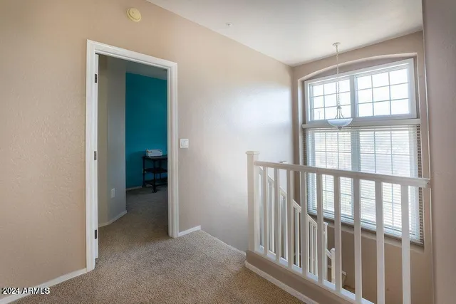 an empty room that has a window and wooden floor