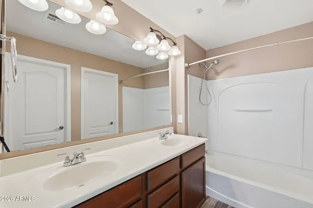 a bathroom with a sink a shower and a mirror