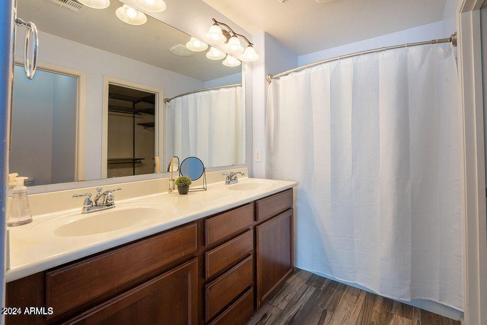 4757 East Waterman Street, Unit 103 Gilbert, AZ 85297 - Photo 26 of 27 a bathroom with a double vanity sink and a mirror