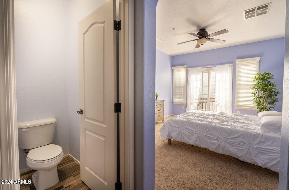 4757 East Waterman Street, Unit 103 Gilbert, AZ 85297 - Photo 27 of 27 a bathroom with a toilet sink and a mirror