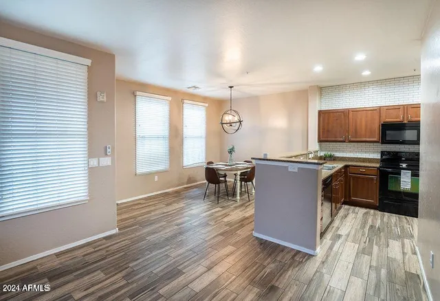 a kitchen with a sink cabinets and wooden floor