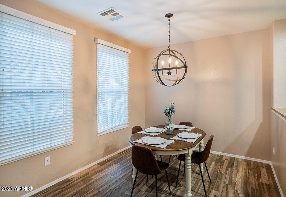 4757 East Waterman Street, Unit 103 Gilbert, AZ 85297 - Photo 6 of 27 a view of a dining room with a table and chairs