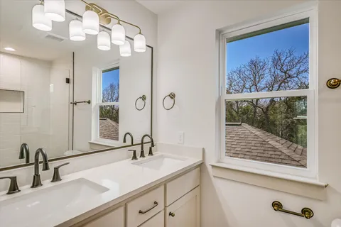 a bathroom with a sink a vanity and a mirror