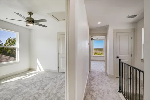 a view of hallway with livingroom and a window