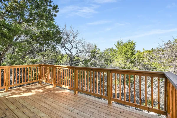 a balcony with wooden floor and fence