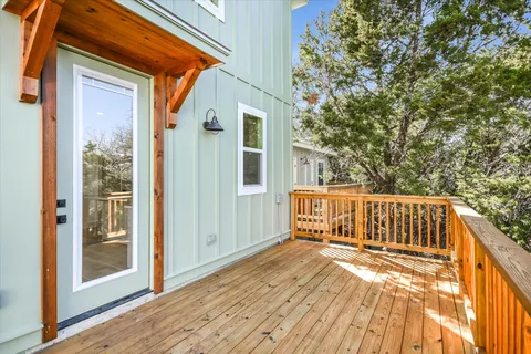 a view of backyard with deck and wooden floor