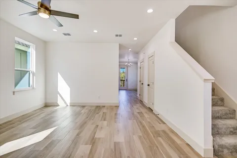 a view of interior space with wooden floor and ceiling fan