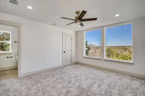 a view of a livingroom with a ceiling fan and window
