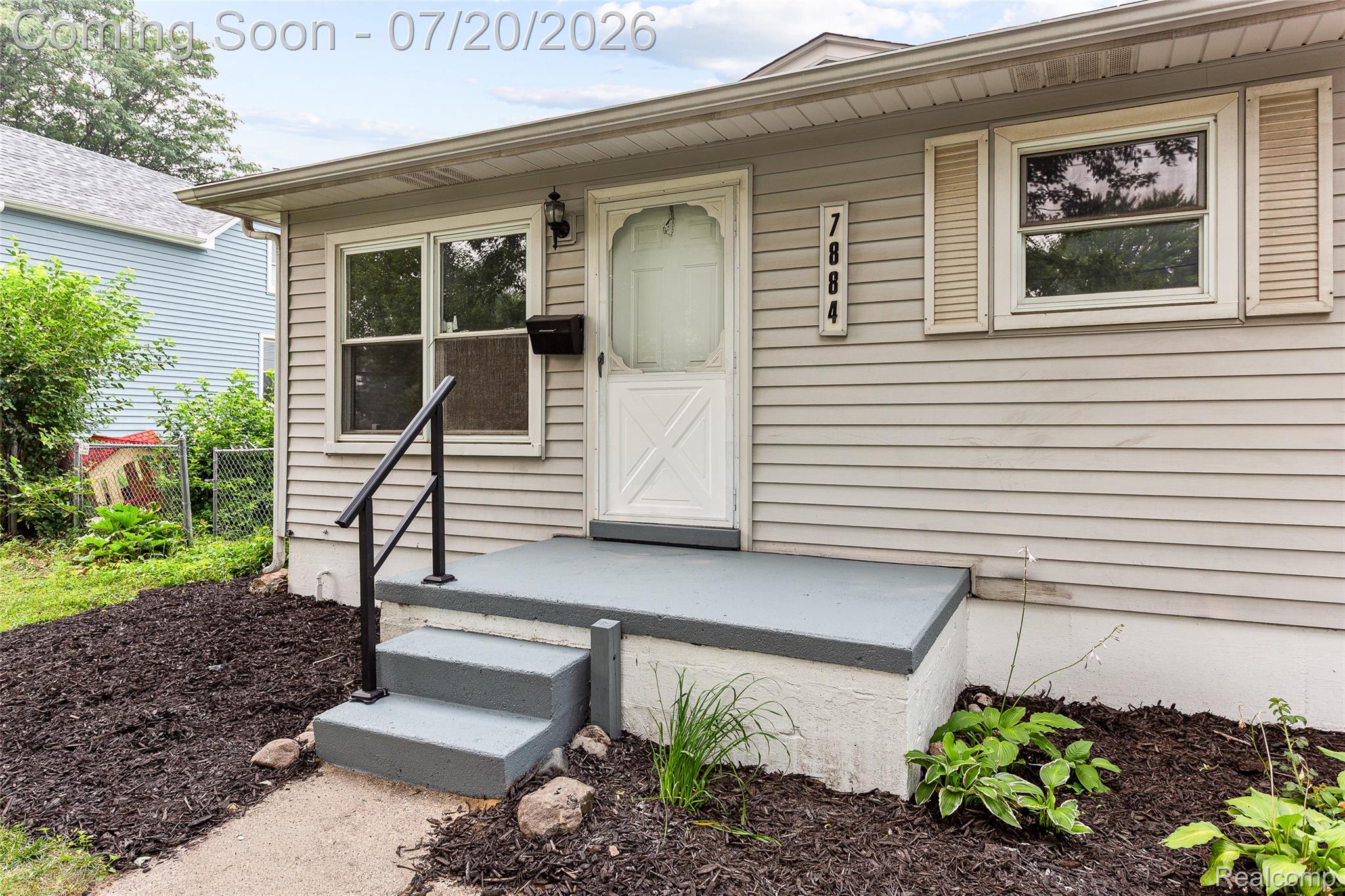 7884 Pardee Road Taylor, MI 48180 - Photo 1 of 23 Exterior facade featuring light-colored horizontal siding, a white entry door, and painted shutters