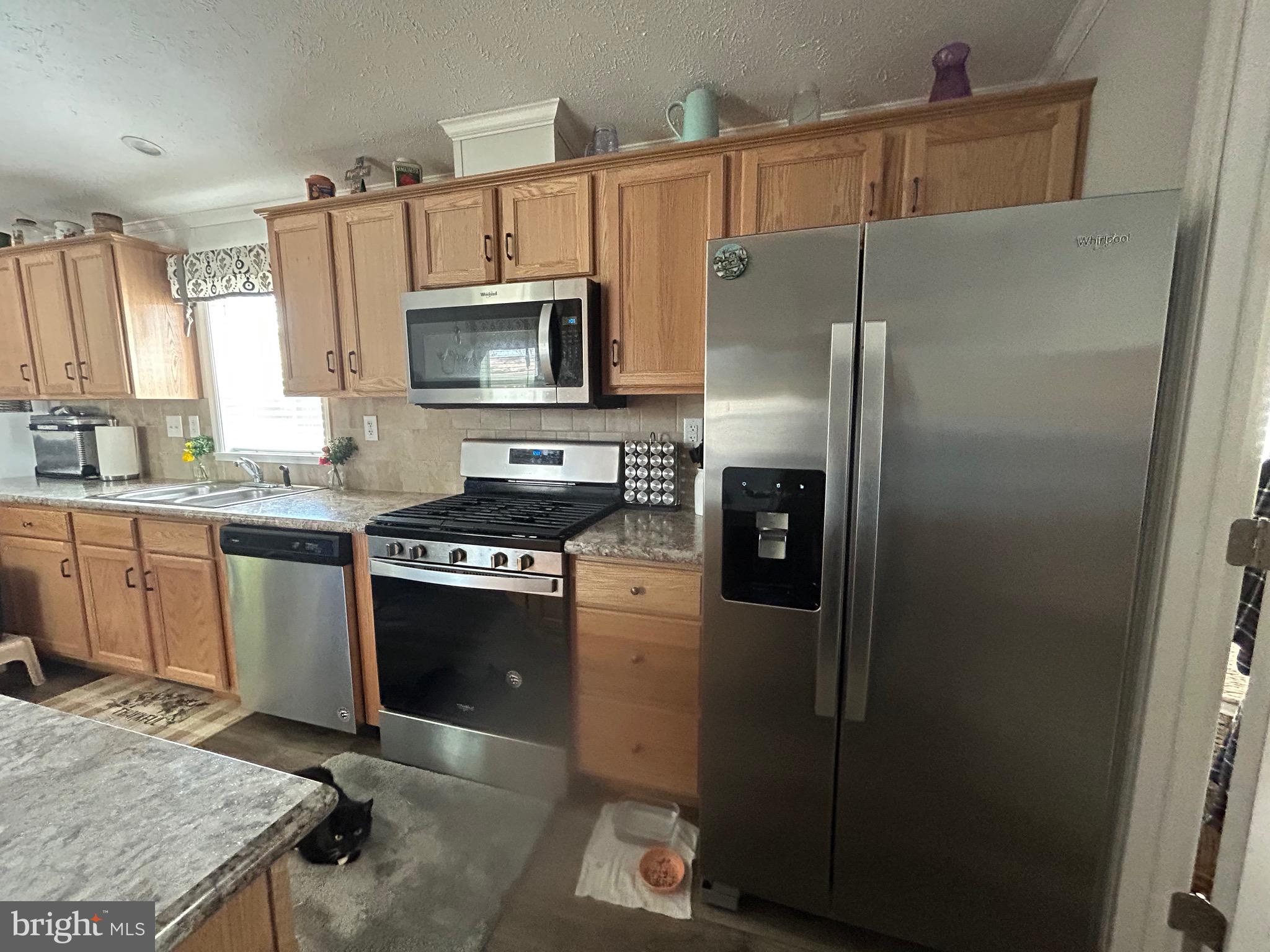 18 Jade Drive Lititz, PA 17543 - Photo 30 of 39 a kitchen with stainless steel appliances granite countertop a refrigerator a stove a sink and a microwave