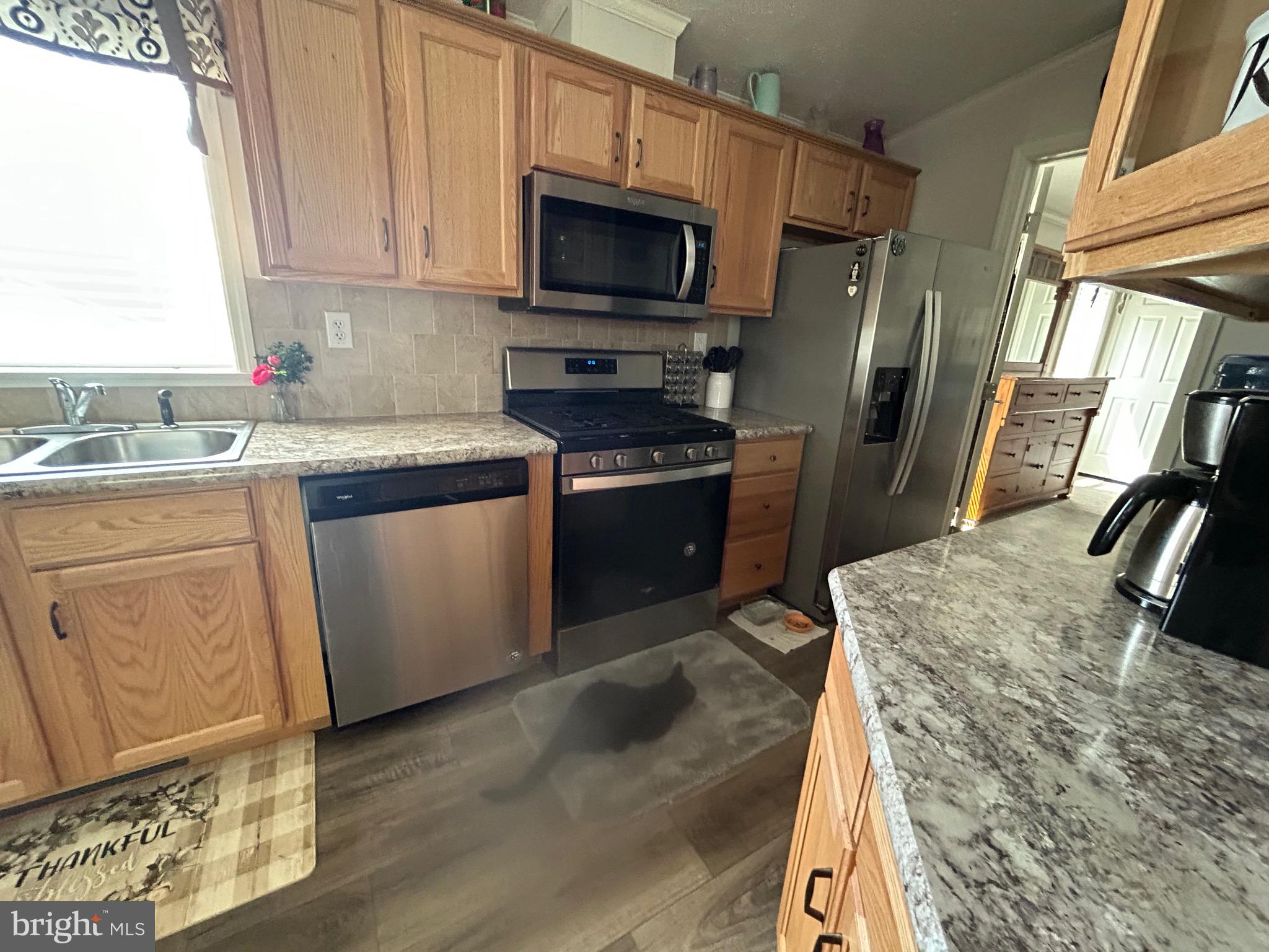 18 Jade Drive Lititz, PA 17543 - Photo 31 of 39 a kitchen with stainless steel appliances granite countertop a stove a sink and a microwave