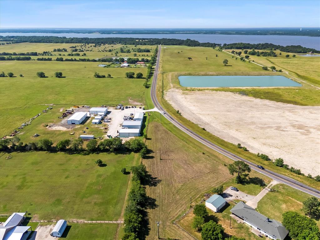8982 Fm 2101 Quinlan, TX 75474 - Photo 6 of 13 Aerial view of property and surrounding area featuring rural landscape, a large body of water, and agricultural land
