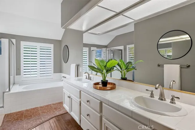 a bathroom with a double vanity sink and a mirror