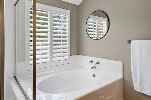 a bathroom with a bathtub and a window