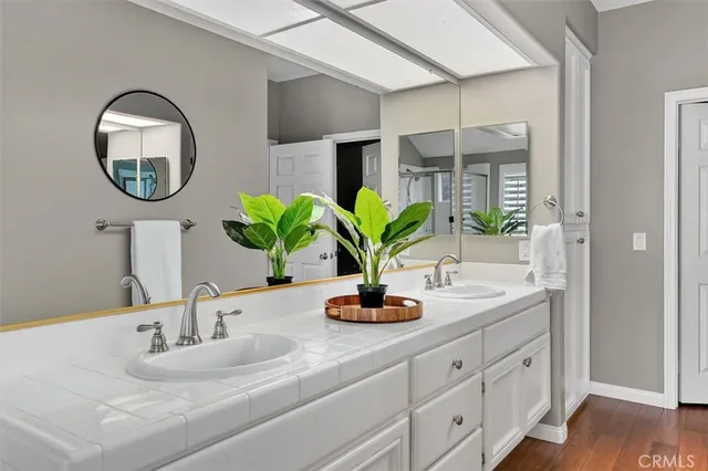 a bathroom with a double vanity sink and a mirror