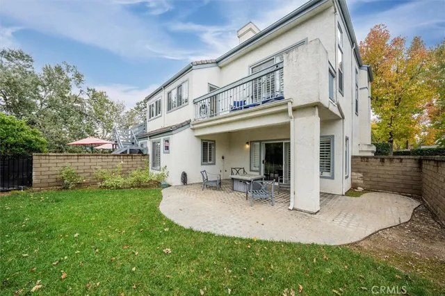 a view of a house with backyard porch and sitting area