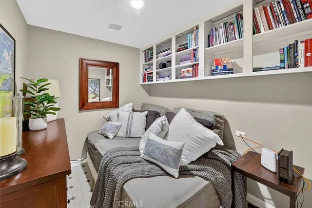 a bedroom with furniture and a book shelf